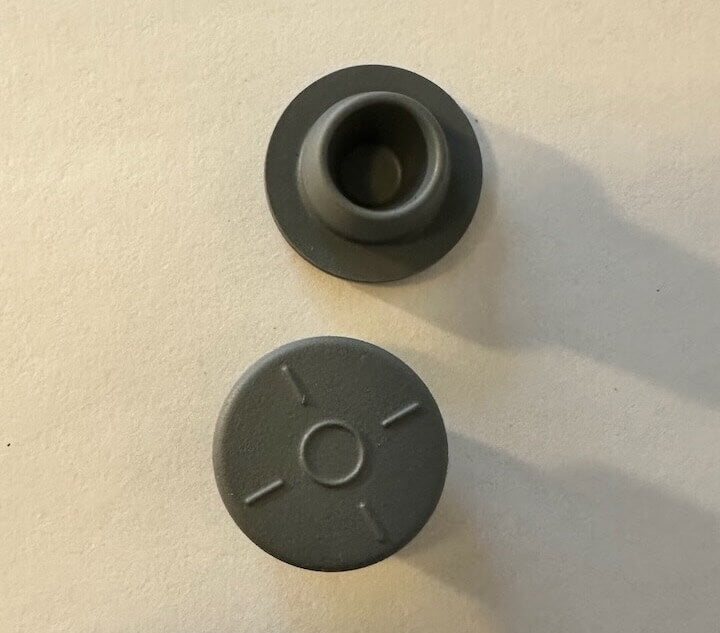 Grijze LEGO-onderdelen op een witte achtergrond.