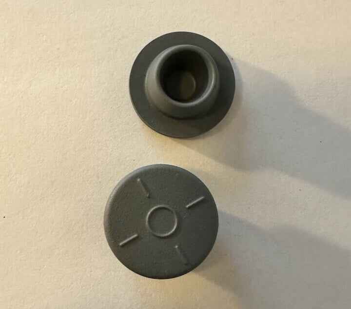 Grijze LEGO-onderdelen op een witte achtergrond.